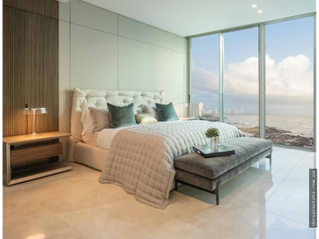 Luxury master bedroom with floor-to-ceiling Pacific Ocean view windows in Punta Pacifica