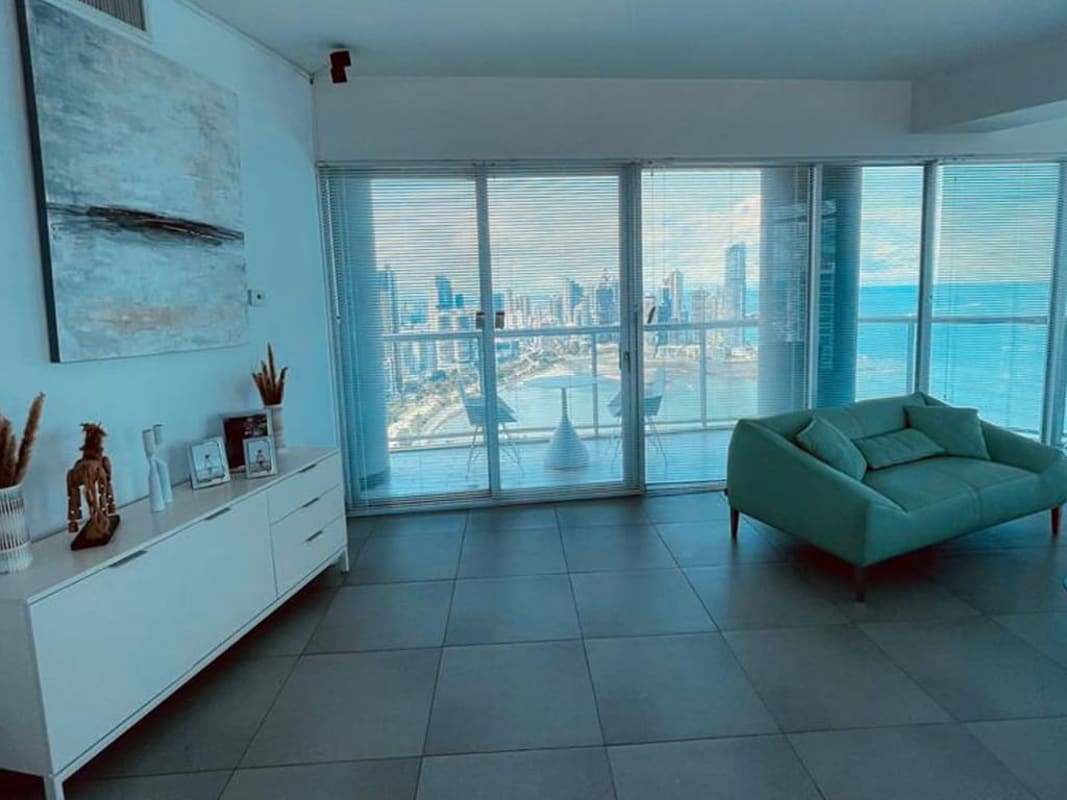 Large balcony with glass railing facing Pacific Ocean and city skyline in PH Yacht Club Panama