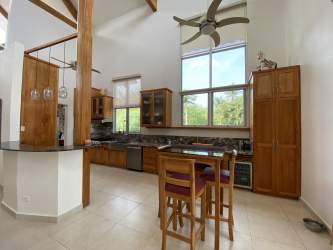 Contemporary kitchen with marble countertops, wood cabinetry Punta Barco