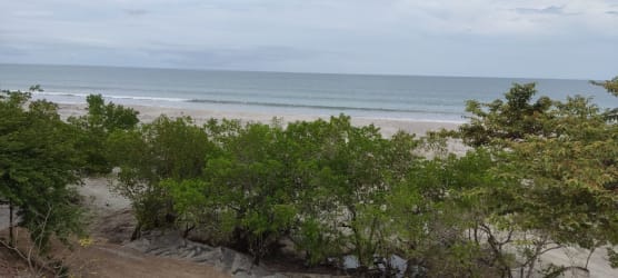 Flat sandy terrain with coastal vegetation and panoramic Pacific view at El Higo Panama