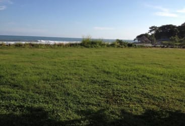 Aerial photo showing oceanfront triangular land lot with natural vegetation at Punta Barco Panama