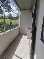 Interior hallway with patterned tile windows exit sign Barrio Balboa apartment La Chorrera Panama