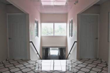 Bright stairway corridor with tiles windows and rail Barrio Balboa apartment La Chorrera Panama