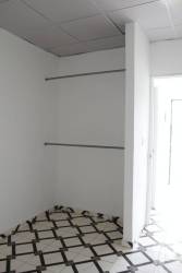 Minimalist closet with built-in rods tiled floor white walls Barrio Balboa apartment La Chorrera Panama