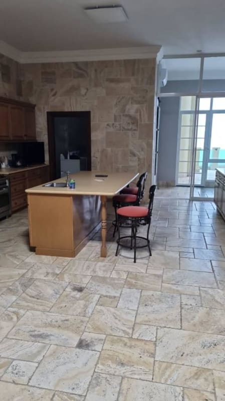 Spacious traditional kitchen with island, wood cabinetry at Bellagio Punta Pacifica Panama