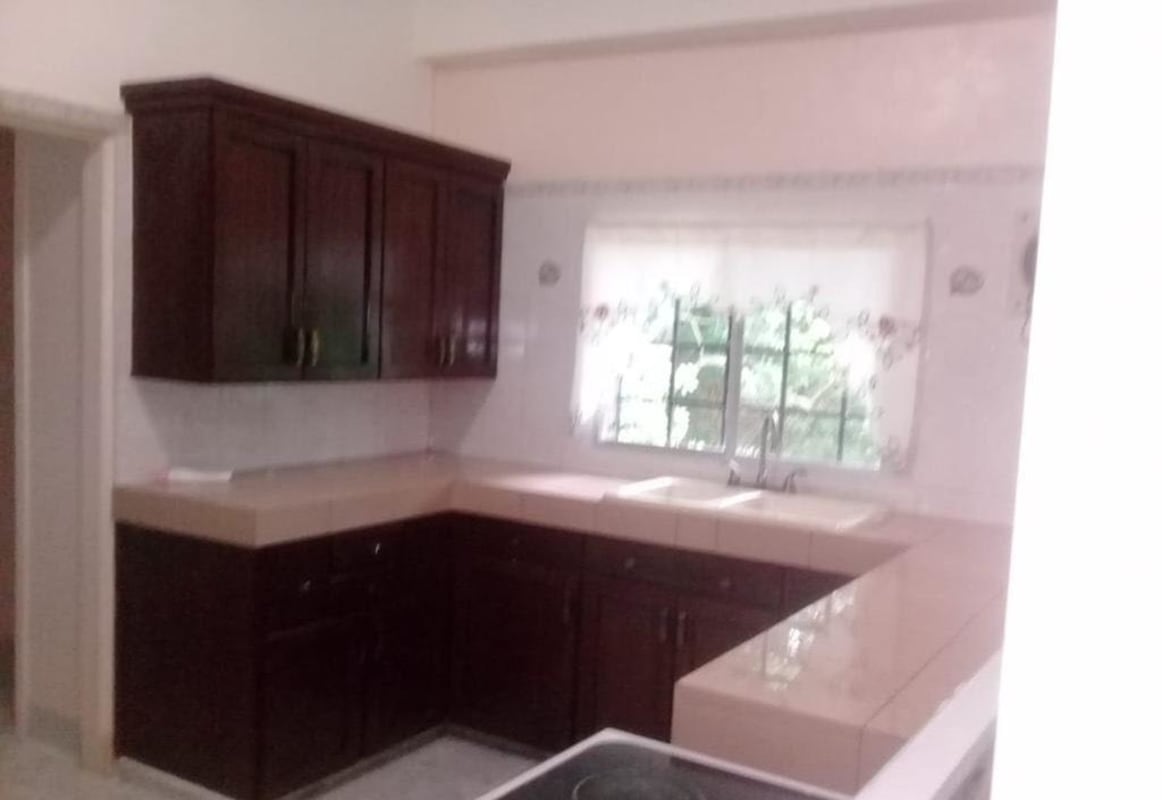 Kitchen with tiled countertops, L-shape layout and wood cabinets PH Albrook Gardens Clayton Panama