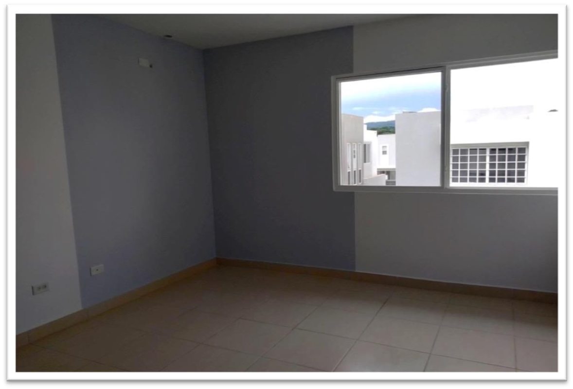 Sunlit bedroom with tiled floor and window in PH Augusta Brisas del Golf Panama