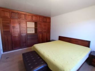 Spacious open-plan living dining room, striped sofas, stone feature wall, large windows Alto Boquete Panama