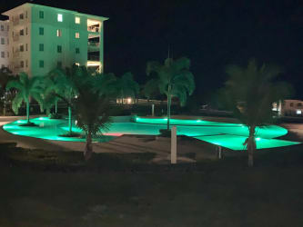 Large beachfront swimming pools, palm gardens, and oceanfront residential towers Bijao Panama