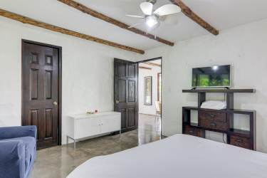 Bright master bedroom with balcony ocean view wood beams Costa Esmeralda Panama