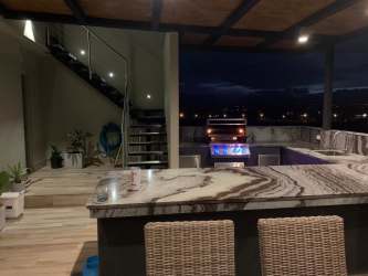 Open concept living dining room with large windows and ocean view terrace Punta Caelo Panama