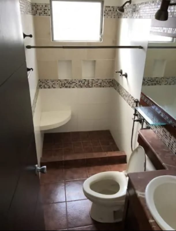 Small bathroom with step-up shower mosaic accents, glass shelf in Los Angeles Panama House