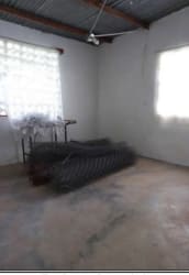Bedroom with concrete floor metal roof unfinished space Barrio Balboa La Chorrera Panama