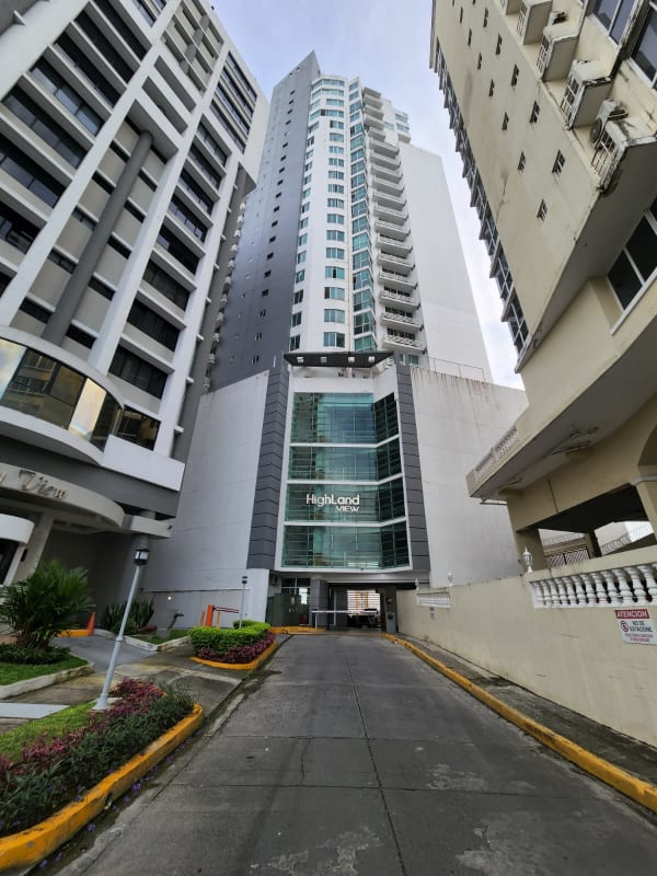 Modern tall condominium tower with glass facade and balconies at PH Highland View Hato Pintado Panama City