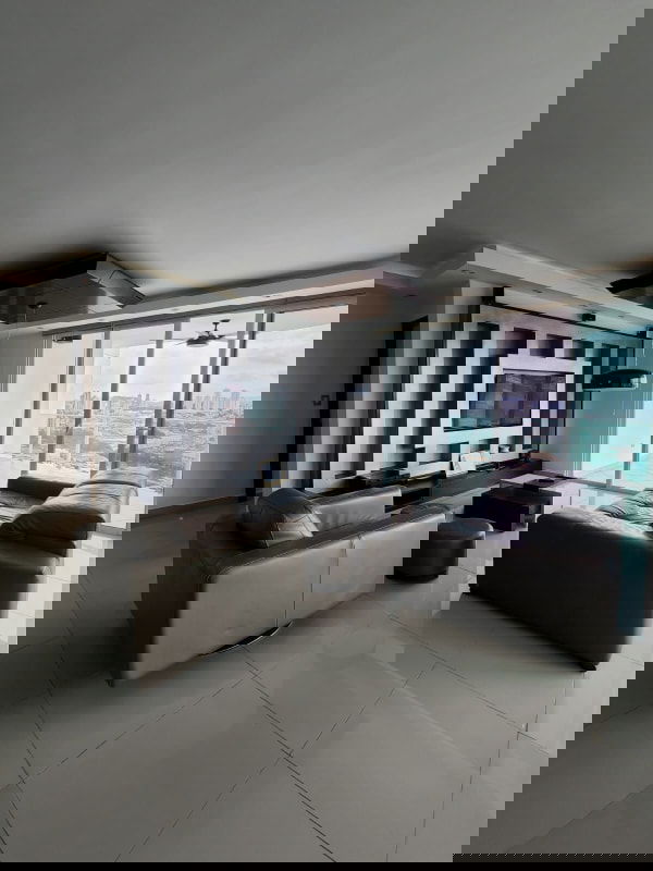 Spacious living room with floor-to-ceiling glass doors showcasing breathtaking city view PH Highland View Panama