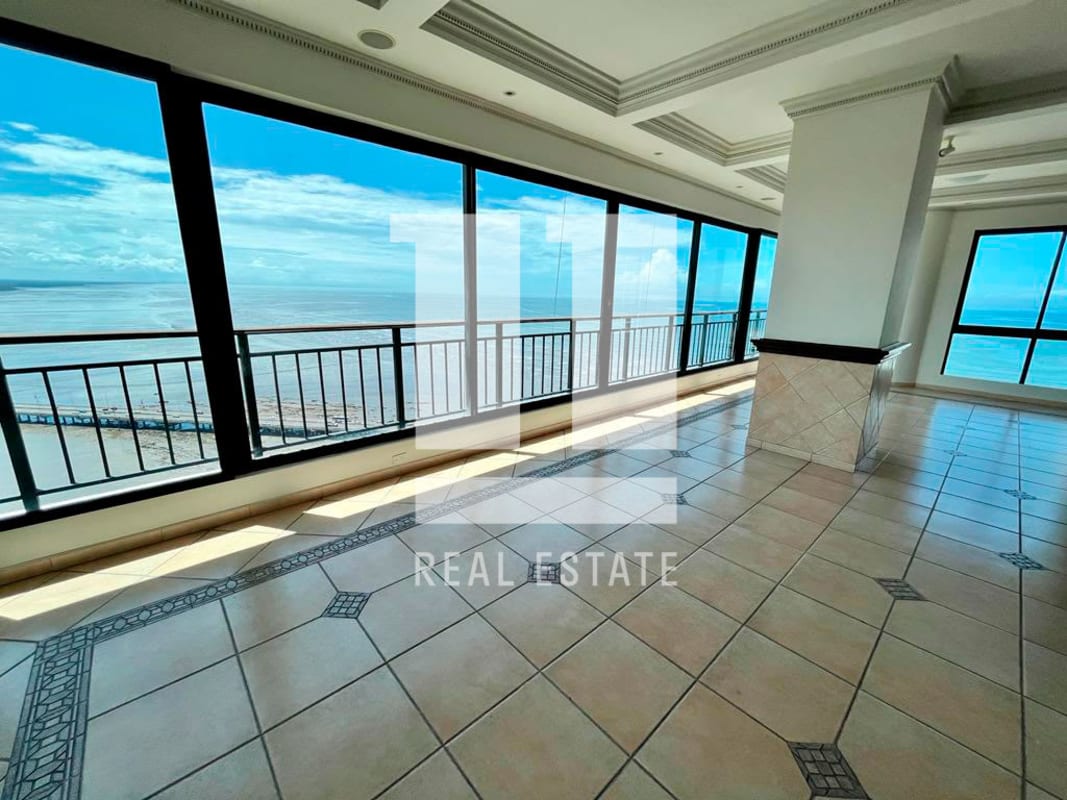 Spacious luxury kitchen with granite counters, white cabinetry and ocean view window in PH Palazzo Coco del Mar Panama