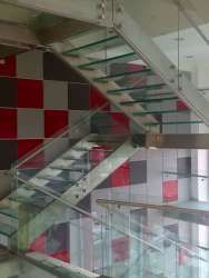 Glass staircase and modern finishes inside multi-story commercial building in Zona Libre Colón Panama