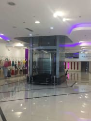 Mall-style atrium with elevators, tile floors and retail units in Zona Libre Colón Panama