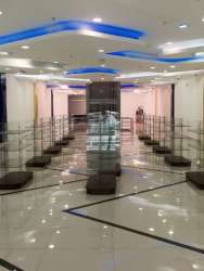 Spacious showroom interior with blue lighting, polished floors in Zona Libre Colon Panama