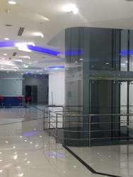 Spacious entrance lobby area with elevator and blue accent lights in Zona Libre Colón