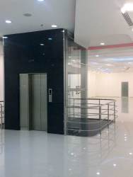 Elevator area with accent lighting and polished floors in multi-level commercial building Panama