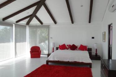 Scenic sandy beach, turquoise ocean, coastal vegetation at private estate Vistamar resort