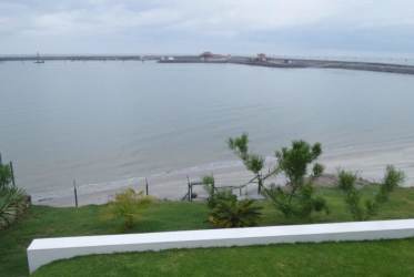 Spacious bedroom with exposed beams, floor-to-ceiling window with garden views in Vistamar luxury home Panama