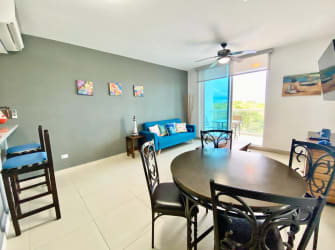 Compact kitchen with granite counters and appliances at Ocean Two Playa Blanca