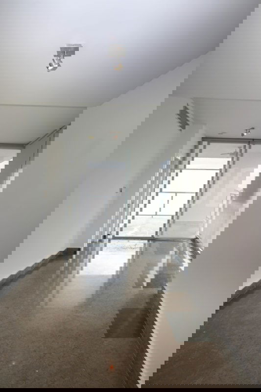 Living room space in PH BICSA Tower with marble flooring and floor-to-ceiling windows