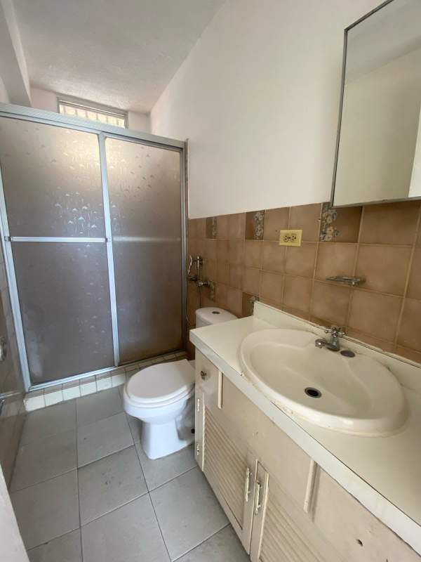 Full bathroom with shower glass door tile walls sink vanity in PH Colonial Panama City