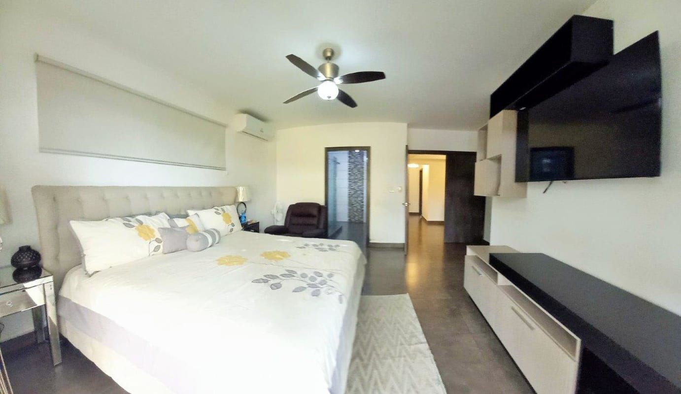 Spacious master bedroom with large bed, ceiling fan, split AC, walk-in closet and balcony in Altos de Panamá