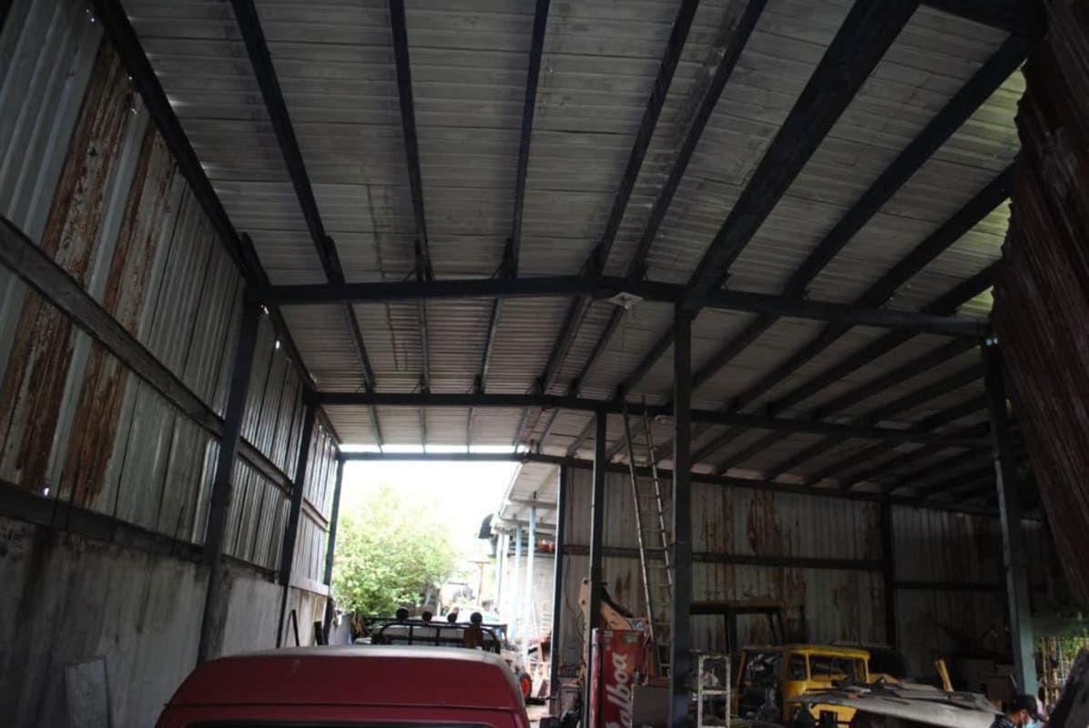Interior of spacious warehouse with open entrance, metal roof, Parque Lefevre Panama