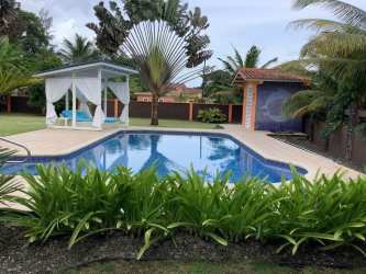 Lush tropical garden and private swimming pool in gated beachfront home Costa Arriba Portobelo