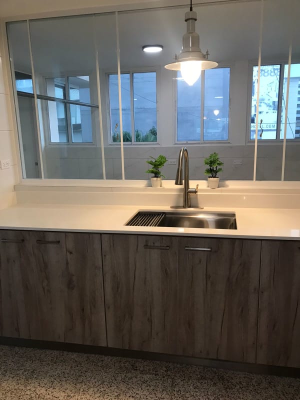 Modern kitchen with electric stove, granite countertops, wood cabinets at PH Florida Obarrio Panama