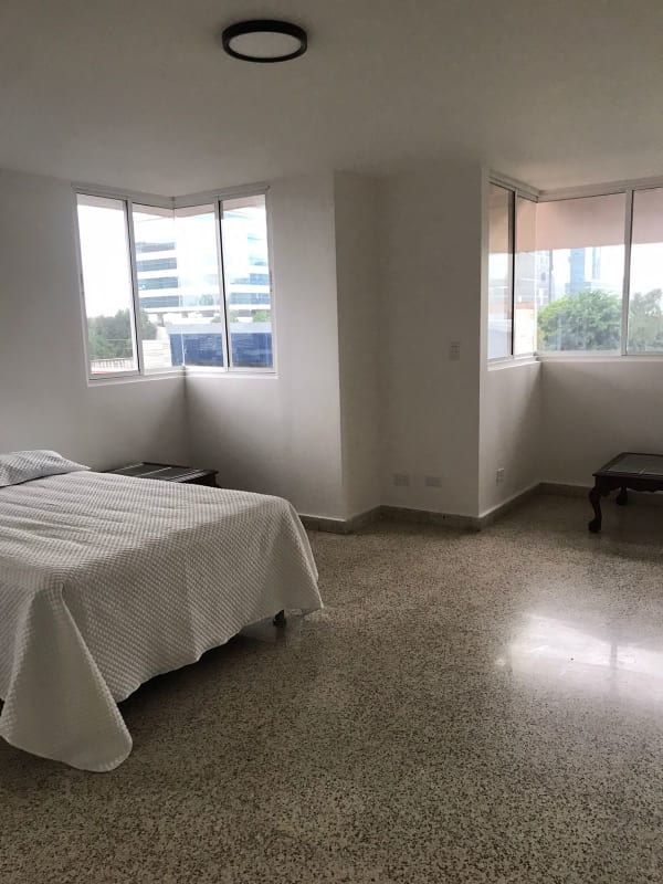 Modern kitchen with stainless sink, glass divider, wood grain cabinets at PH Florida Obarrio Panama