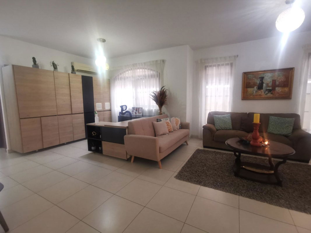 Contemporary living room with sliding glass doors, tile flooring and natural light Ciudad Radial Panama