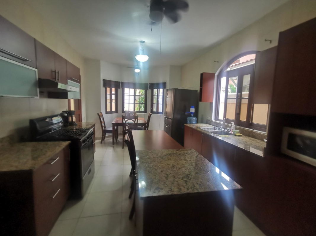 Outdoor patio with children playground set on turf in gated Ciudad Radial Panama