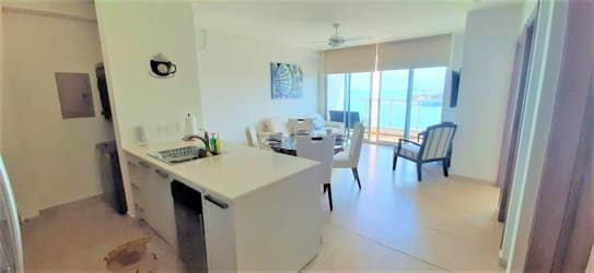 Open plan living dining room with large windows and ocean views at Royal Palm Nueva Gorgona Panama