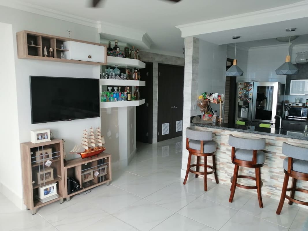 Modern equipped kitchen open to living room with bar counter in PH Pacific Park Edison Park Panama