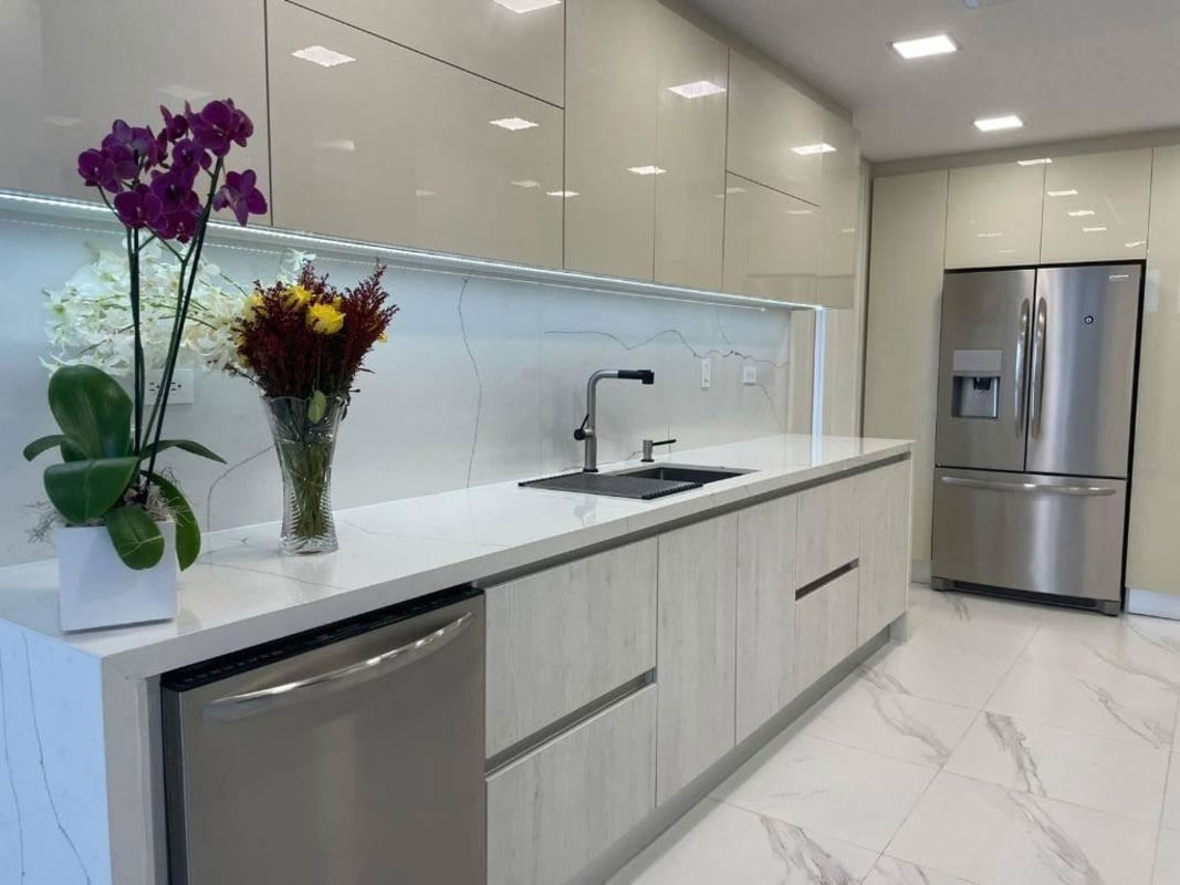 Bright kitchen with marble finish, stainless appliances, modern cabinetry