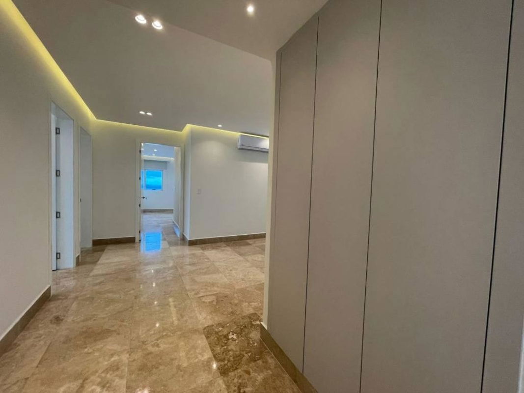 Modern hallway with built-in closets, marble flooring, LED lighting