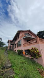 Bright living room with yellow walls, tile floors, ceiling fans, windows Altos del María Panama