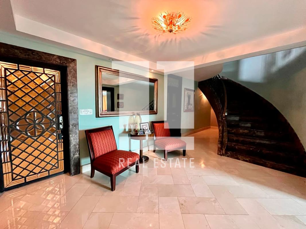 Elegant marble staircase with wrought iron rail in luxury penthouse PH Golf Tower Panama