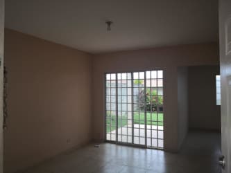 Living room in La Chorrera house with sliding glass doors to private backyard