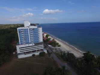 Aerial view beachfront condominium PH Playa Corona with glass facade and coastline panorama San Carlos Panama