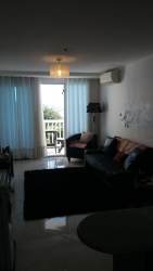 Modern beach apartment living room with balcony access and stunning sea views in San Carlos Panama