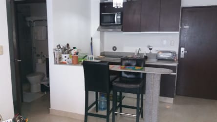 Compact kitchen with granite countertop, appliances and breakfast bar in PH Playa Corona San Carlos Panama