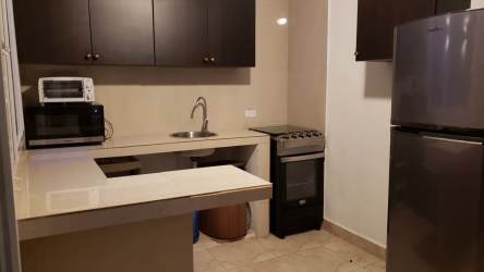 Bedroom with queen bed, double bed, bunk bed, air conditioning and TV at Suite Venezia Coronado Panama