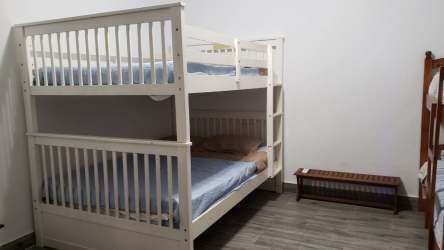 Covered patio terrace with lounge chairs poolside at Casablanca Coronado vacation house