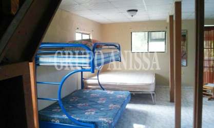 Rustic blue and white cabin exterior porch with hanging décor Altos del Cerro Azul Panama